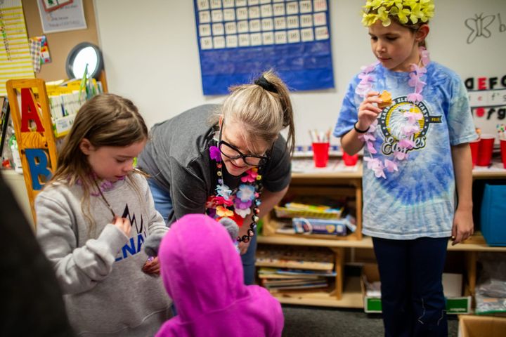 Kindergarten teacher Rebekah Taylor hands out free books and toys to children