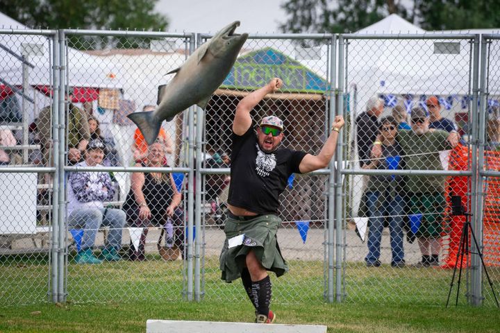 Danny Autrey, the state's first professional Highland Games athlete, throws a fish at the 2025 Alaska Scottish Highland Games