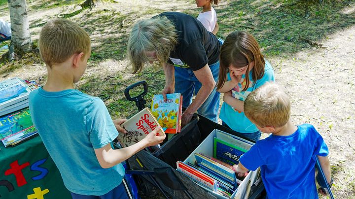 Bright Lights Book Project Executive Director Alys Culhane hands out "garden" themed books