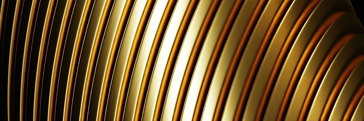 Abstract close-up of curved, polished gold bands catching the light