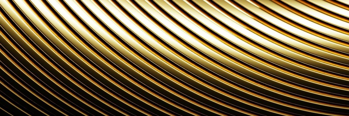 Abstract close-up of curved, polished gold bands catching the light