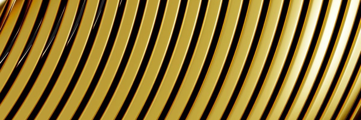 Abstract close-up of curved, polished gold bands catching the light