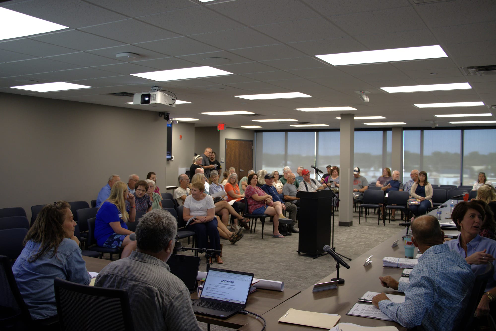 Meeting watchers slowly file into the McPherson County Planning and Zoning Appeals Board room on Aug. 17, 2026. (Matthew Petillo/Citizen Journal)
