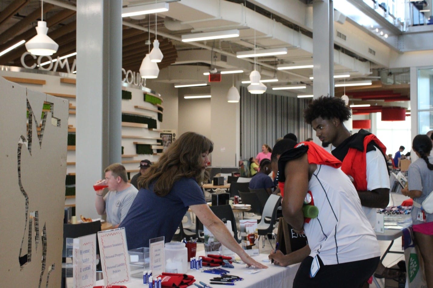 Tiffany Neel talks to McPherson College students about different types of insurance at the back-to-school bash at McPherson College on Monday, Aug. 17, 2026. (Sarah Newberry/Citizen Journal)