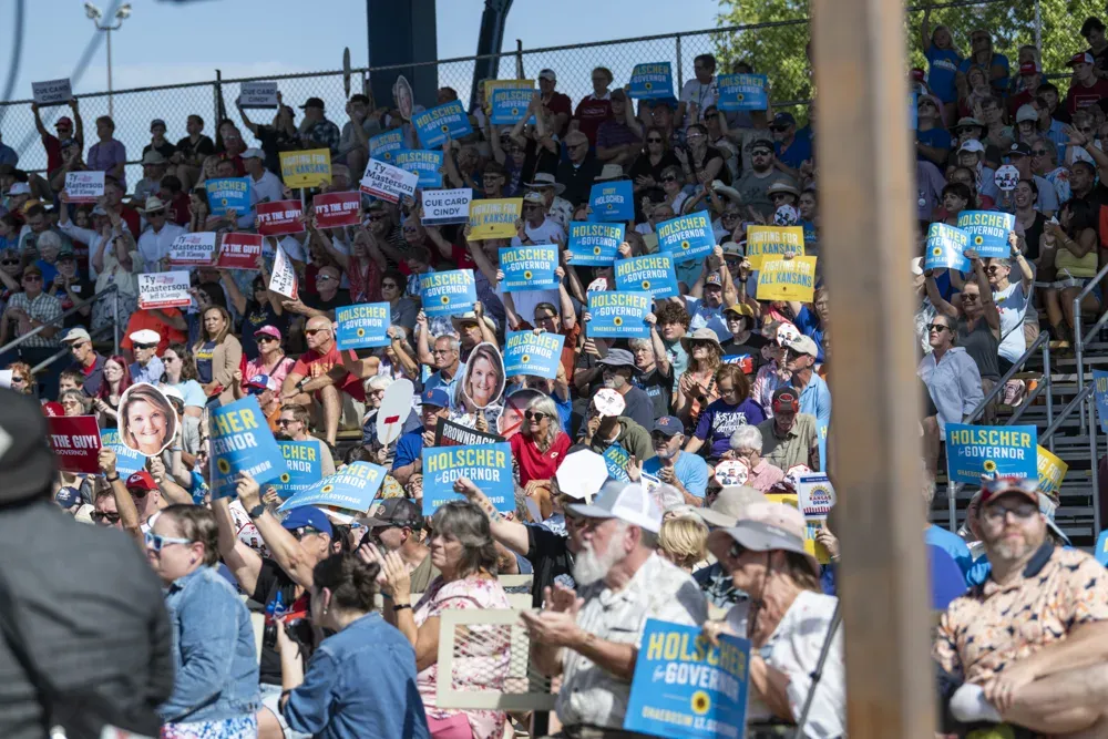 Supporters of Cindy Holscher hold signs during a Kansas gubernatorial debate at the Kansas State Fair on Sept. 12, 2026. (Dale Grosbach for Citizen Journal)