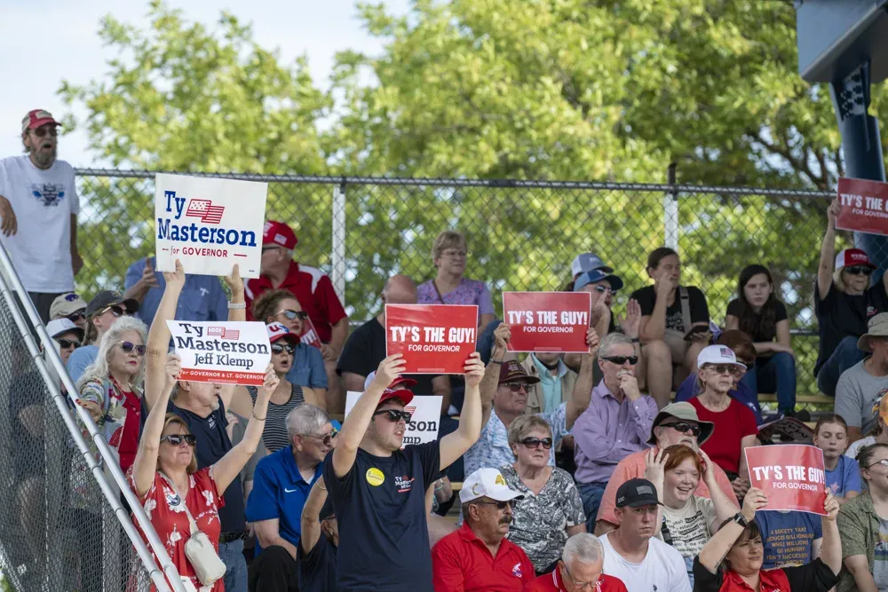 Supporters of Ty Masterson, Republican candidate for Kansas Governor, hold signs up during the Kansas State Fair debate on Sept. 12, 2026. (Dale Grosbach for Citizen Journal)