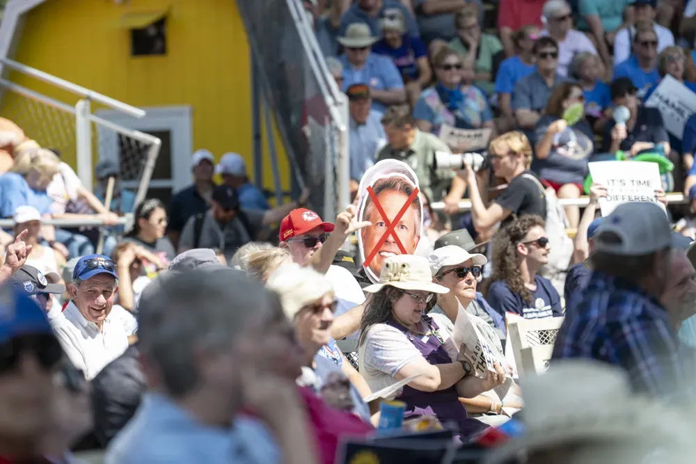 A fair goer holds a sign with a red X covering Sen. Roger Marshall (R-KS)'s face during the Kansas State Fair debate on Sept. 12, 2026. A Citizen Journal photographer noted at the debate that support was about 70-30 in favor of Adam Hamilton, Democratic candidate for U.S. Senate in Kansas. (Dale Grosbach for Citizen Journal)