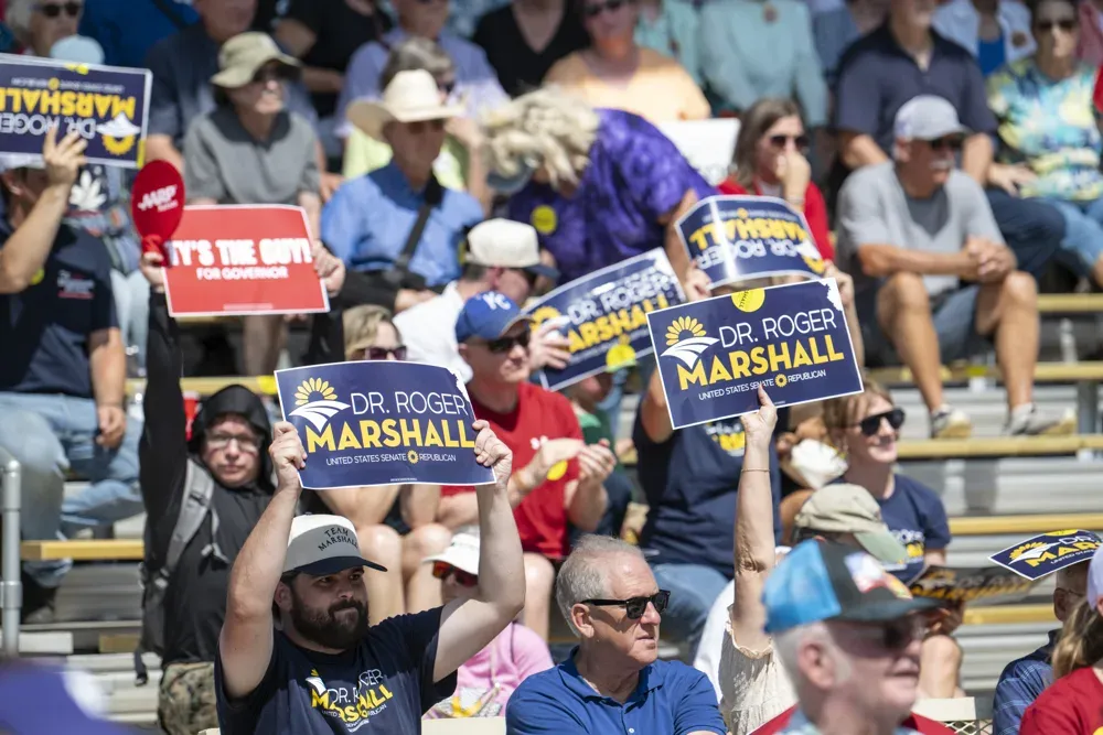 Supporters of Sen. Roger Marshall (R-KS) hold signs during the Kansas State Fair debate on Sept. 12, 2026. (Dale Grosbach for Citizen Journal)