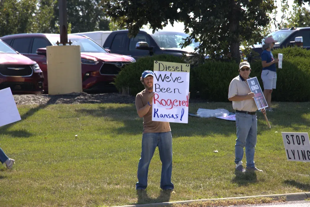 Protesters line the road leading up to a rally featuring Vice President JD Vance in Olathe, Kan. on Sept. 14, 2026. (Matthew Petillo/Citizen Journal)