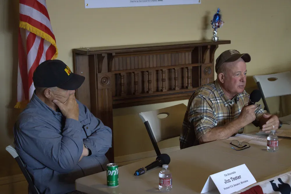 Former Sen. Jon Tester, D-Mont., left, listens to Don Coover, right, who is running in Kansas' 2nd Congressional District as a Democrat, speak during an event in Leavenworth, Kan., on Monday, Oct. 19, 2026. (Matthew Petillo/Citizen Journal)