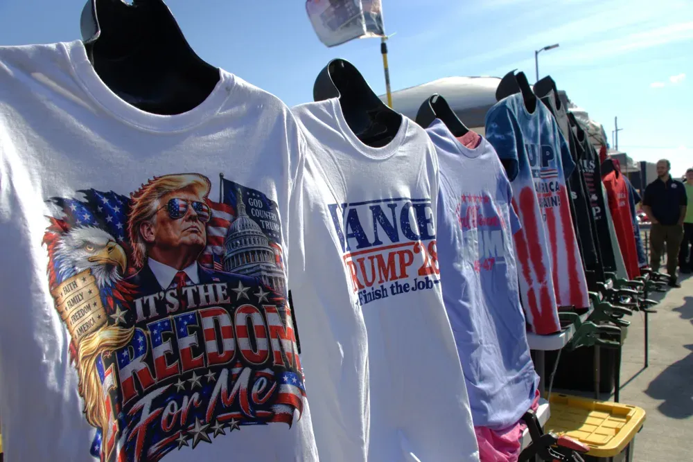 T-shirts are lined up for sale at Vice President JD Vance's rally in Topeka, Kan. on Monday, Oct. 26, 2026. A traveling gift shop can be found at most rallies. (Matthew Petillo/Citizen Journal)