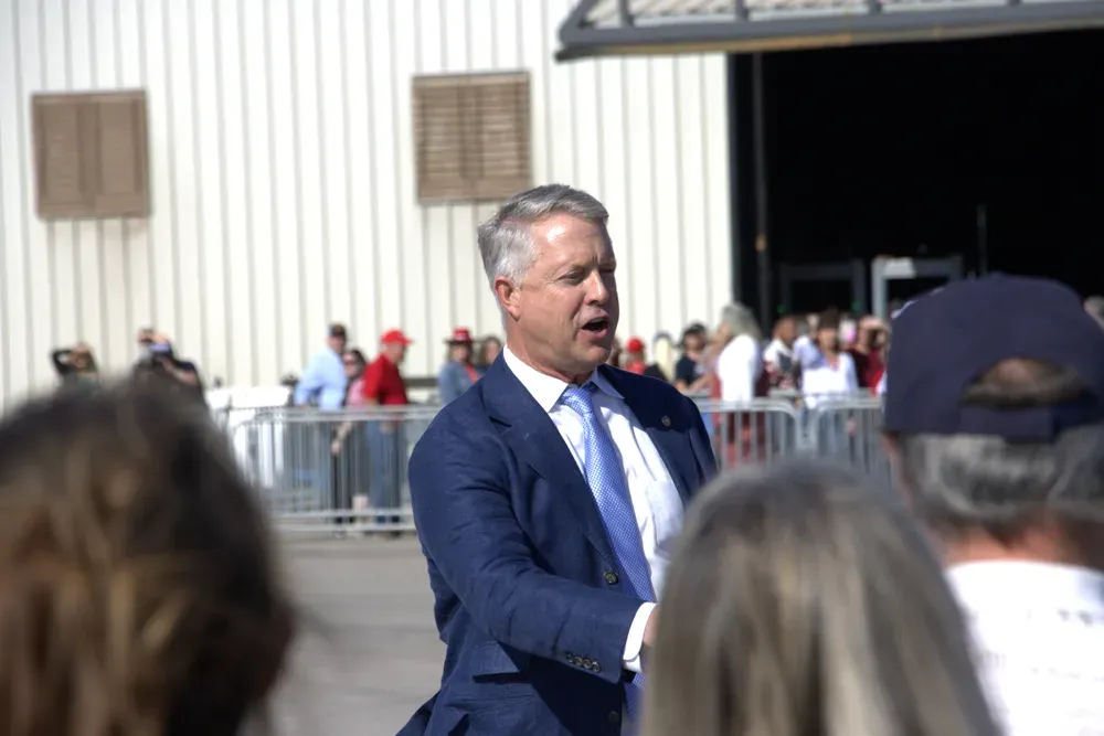 Sen. Roger Marshall, R-Kan., shakes hands with rally attendees as they stand in line to go through security at HME Inc. in Topeka, Kan., on Monday, Oct. 26, 2026. Marshall was also handing out posters that attacked his opponent, Adam Hamilton. (Matthew Petillo/Citizen Journal)