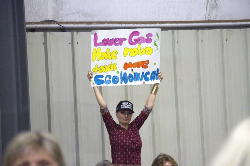 A woman holds a sign during Vice President JD Vance's rally in Topeka, Kan., on Monday, Oct. 26, 2026. (Matthew Petillo/Citizen Journal)