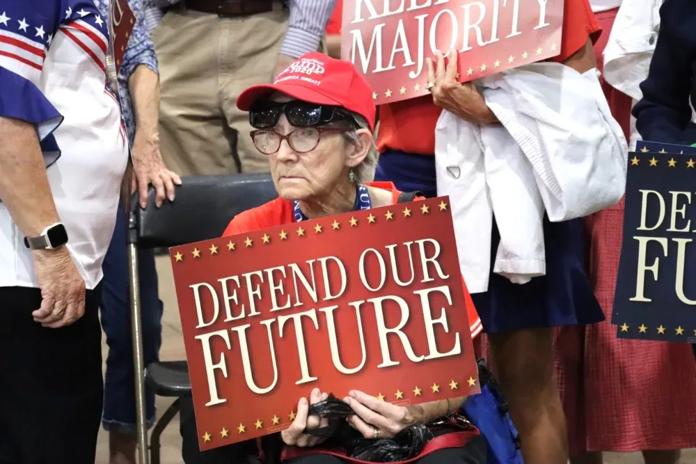 A woman holds a sign during Vice President JD Vance's rally in Topeka, Kan., on Monday, Oct. 26, 2026. (Matthew Petillo/Citizen Journal)