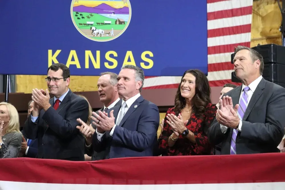 Left to right, Rep. Derek Schmidt, R-Kan., Rep. Tracey Mann, R-Kan., back, gubernatorial candidate Ty Masterson, Heather Kobach, and Kansas Attorney General Kris Kobach clap while Vice President JD Vance speaks in Topeka, Kan., on Monday, Oct. 26, 2026. (Matthew Petillo/Citizen Journal)