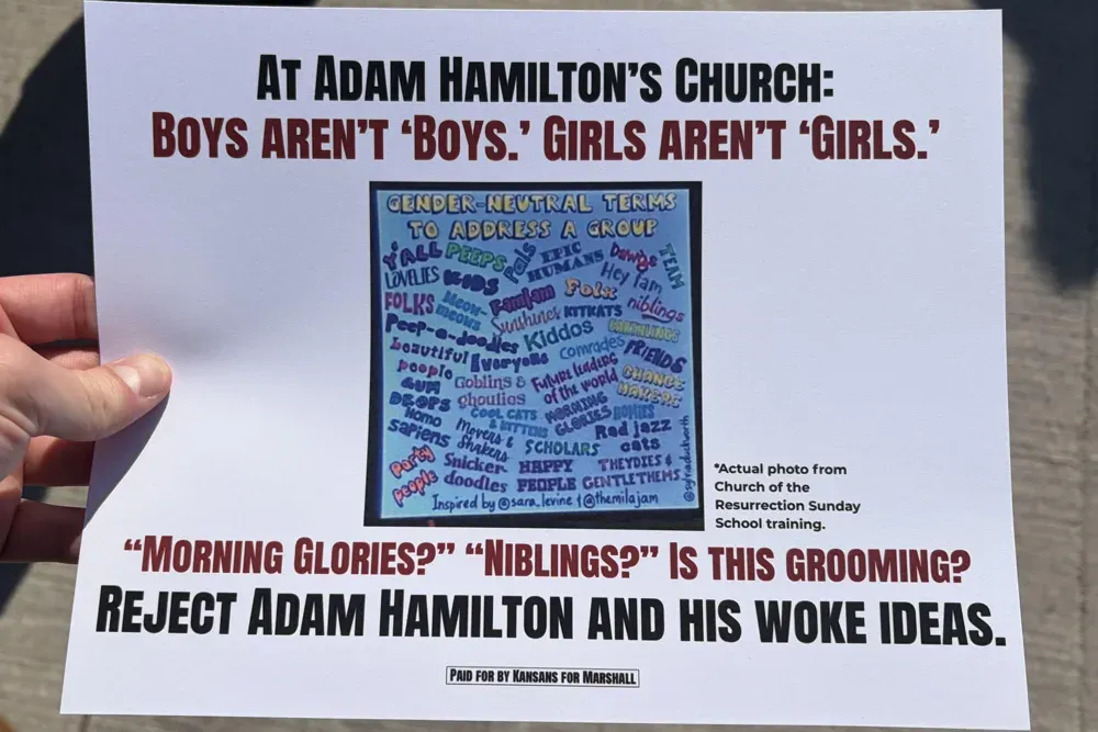 A flier from Sen. Roger Marshall's campaign is held up during Vice President JD Vance's rally in Topeka, Kan., Monday, Oct. 26, 2026. (Matthew Petillo/Citizen Journal)