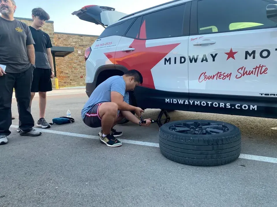 Local teens learn to change tires in hands-on library workshop
