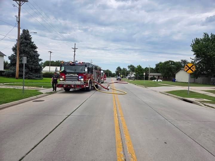 Firefighter escapes injury after falling through roof during McPherson house fire