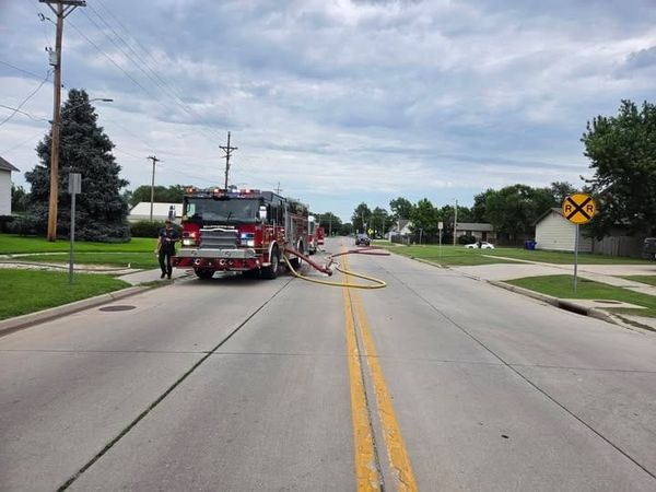 Firefighter escapes injury after falling through roof during McPherson house fire