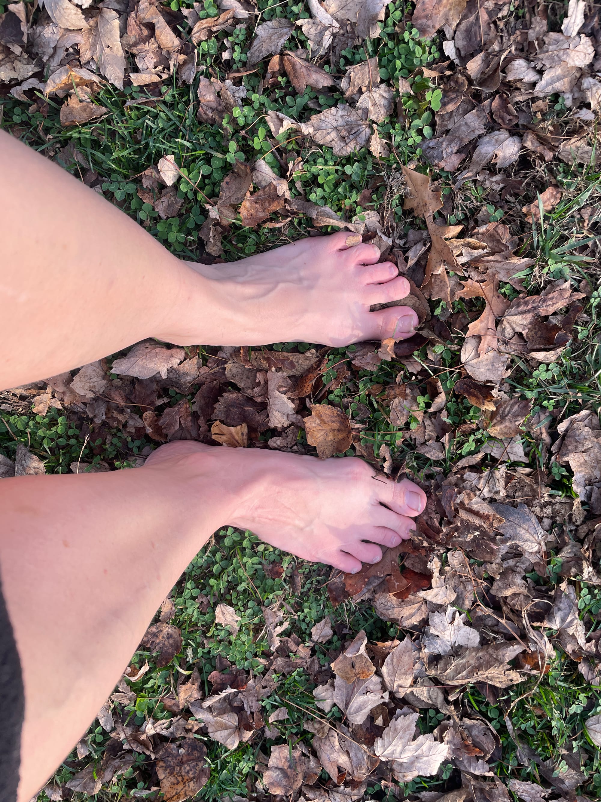 bare feet standing on grass