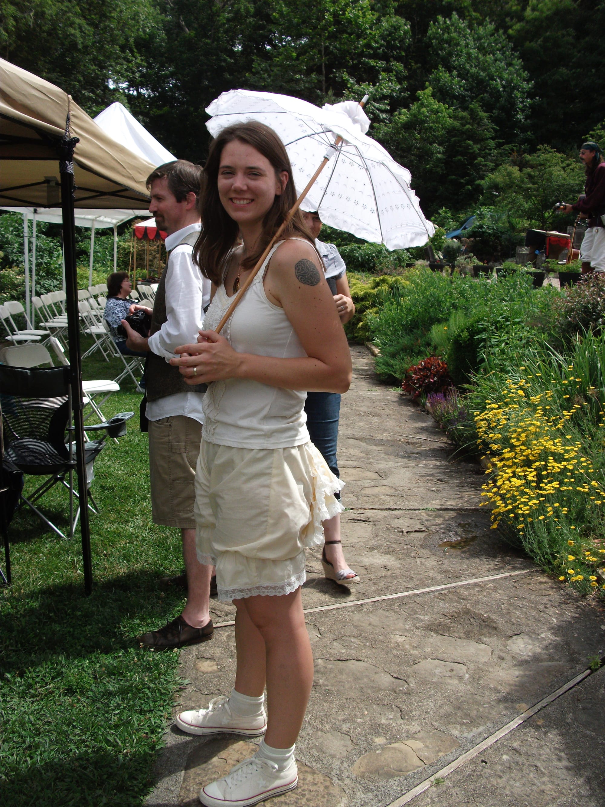 woman in a corset and bloomers holding a parasol