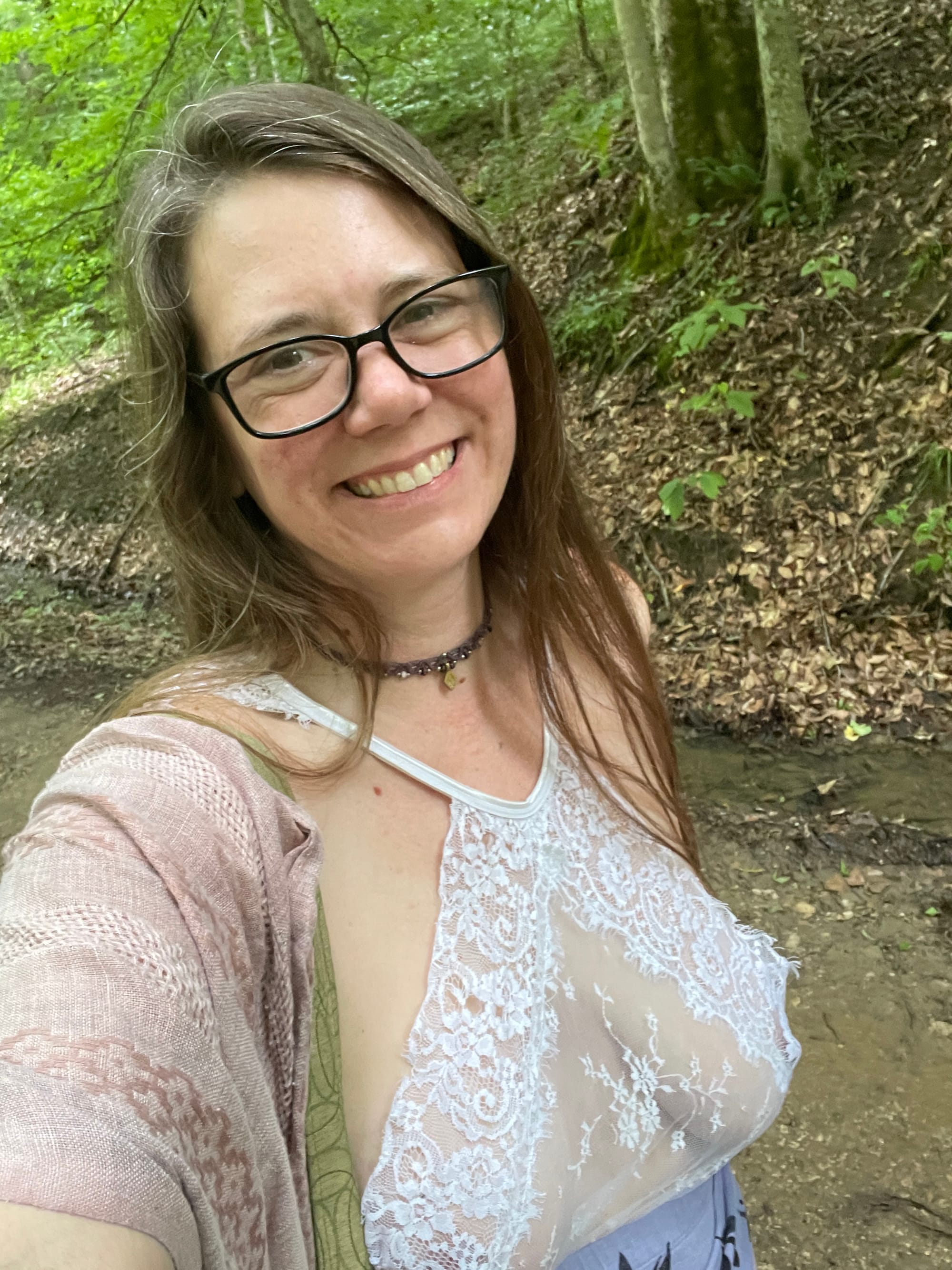 Woman in white top and pink shawl