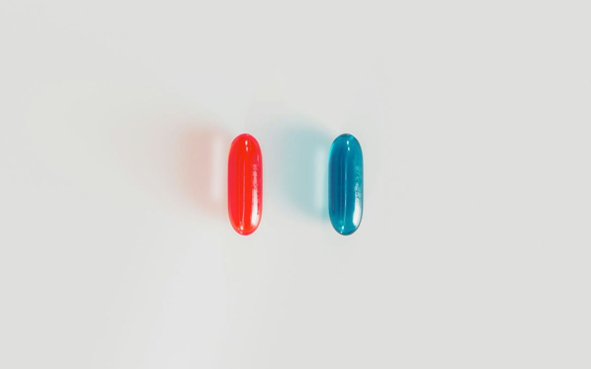 Red and blue pills on a white background