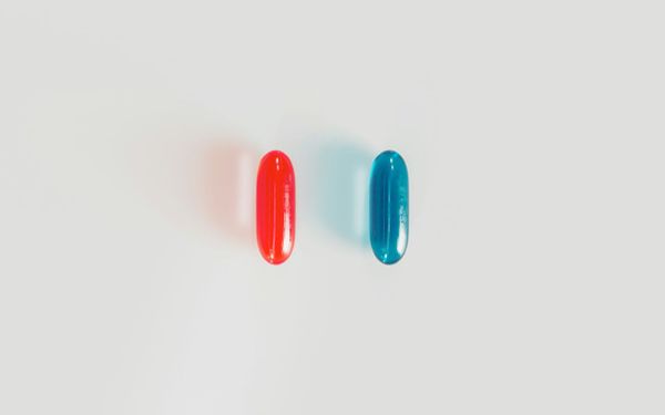 Red and blue pills on a white background