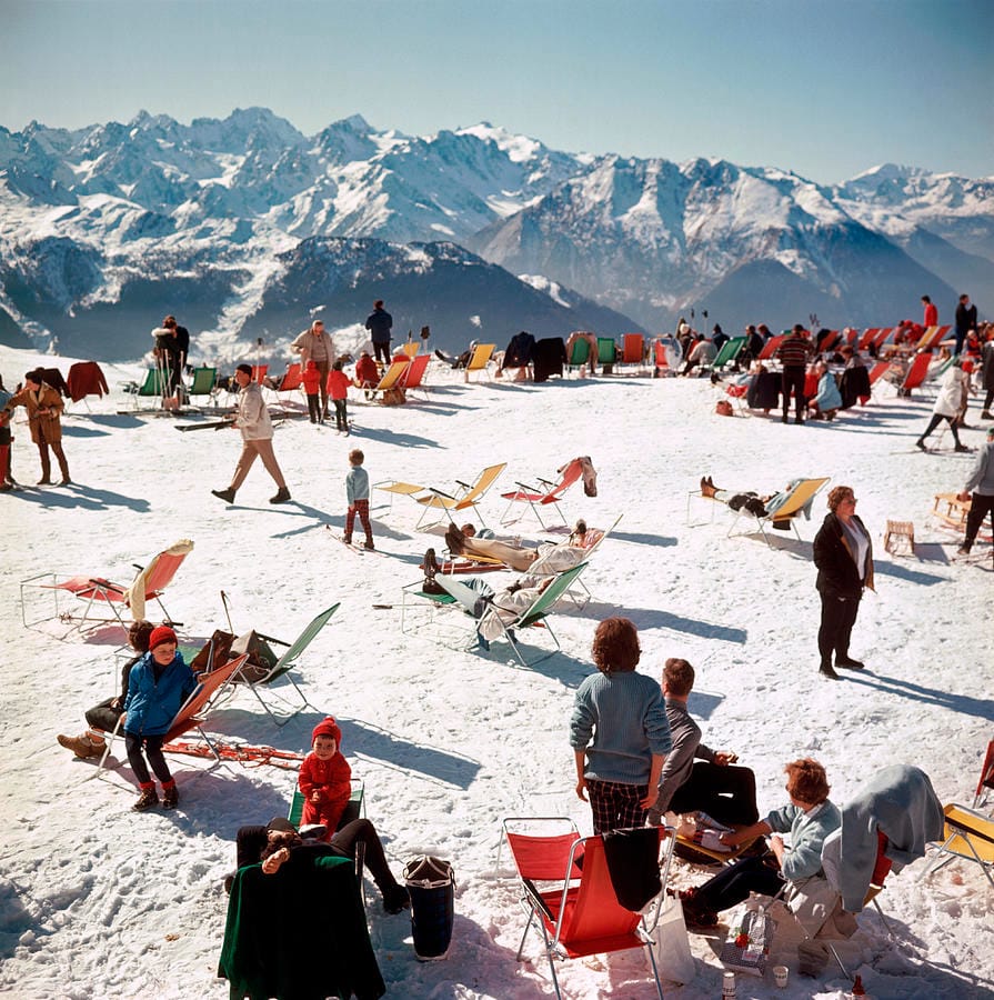 Verbier Vacation — Slim Aarons. Primary colors on a snowfield, the Alps behind.