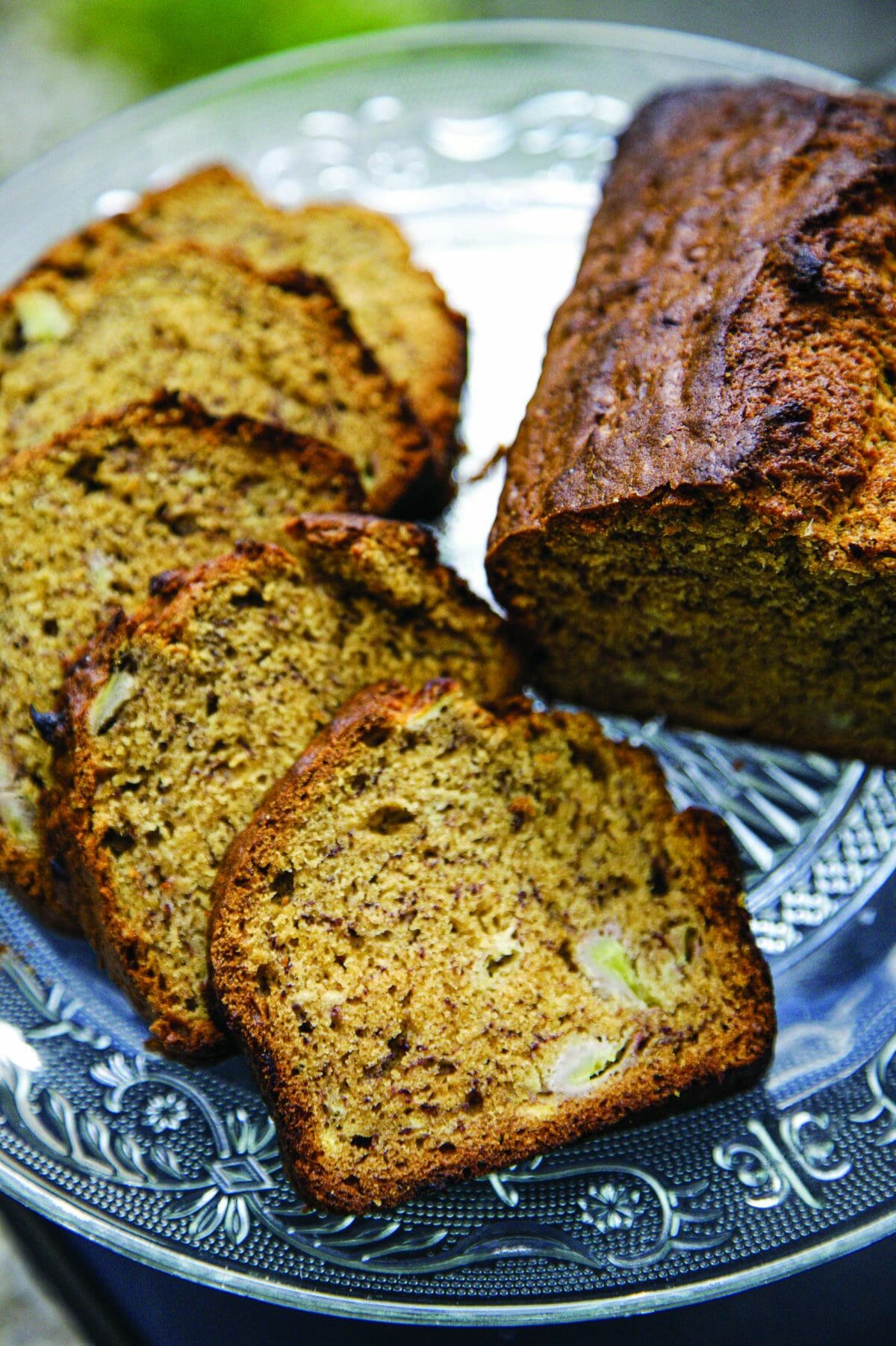En gros plan des tranches de cake à la banane sur une assiette rétro en verre.