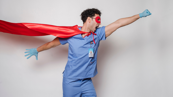 Healthcare worker in a superhero cape.
