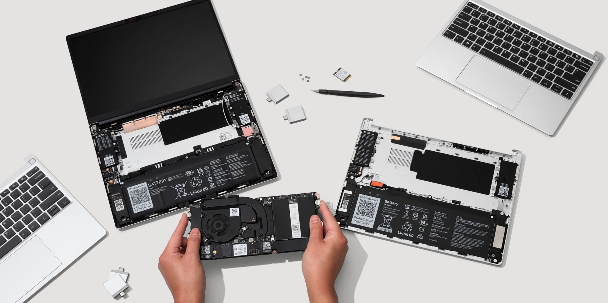 The Framework Pro 13 being assembled by a person's hands.