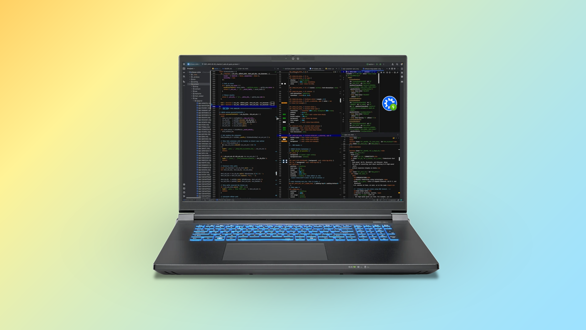 The Kubuntu Focus Zr Gen 2 laptop with a development environment on-screen, on top of a yellow-to-blue gradient background.