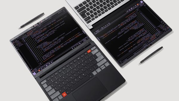 Two Framework Pro 13 laptops with the screens lying flat next to each other and styluses above each screen.