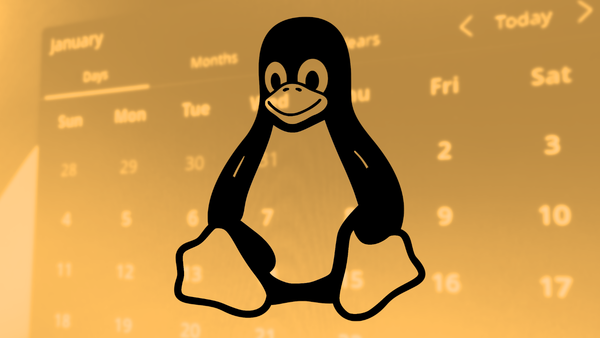 The Linux mascot Tux over an orange photo of a calendar on a computer screen.