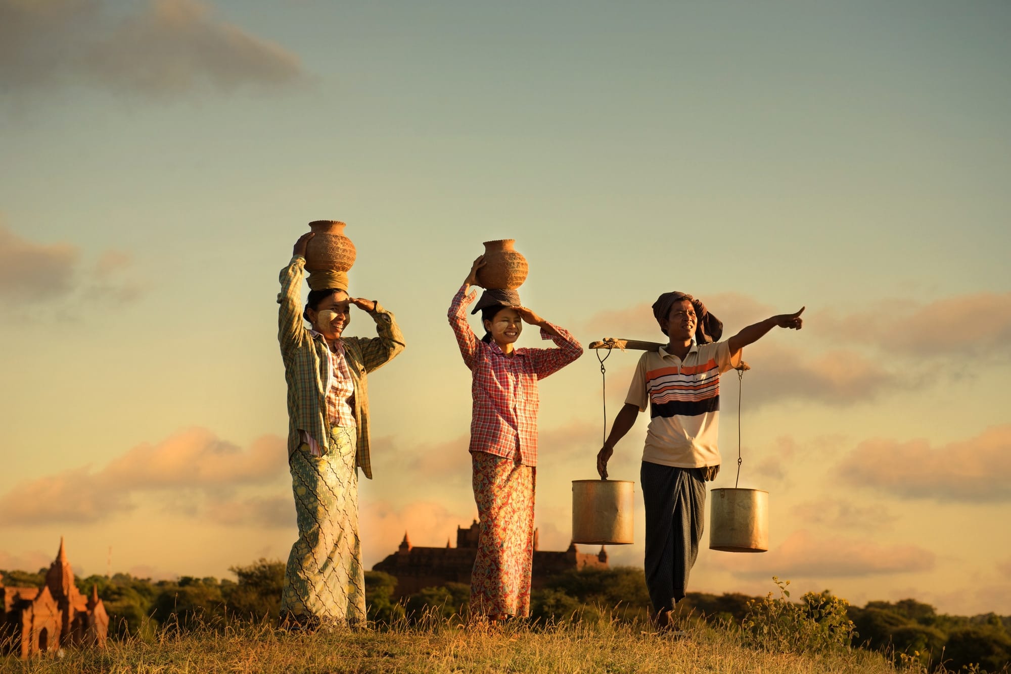 myanmar-pestle-analysis-social traditional asian farmer during sunset at a rice field in bagan,