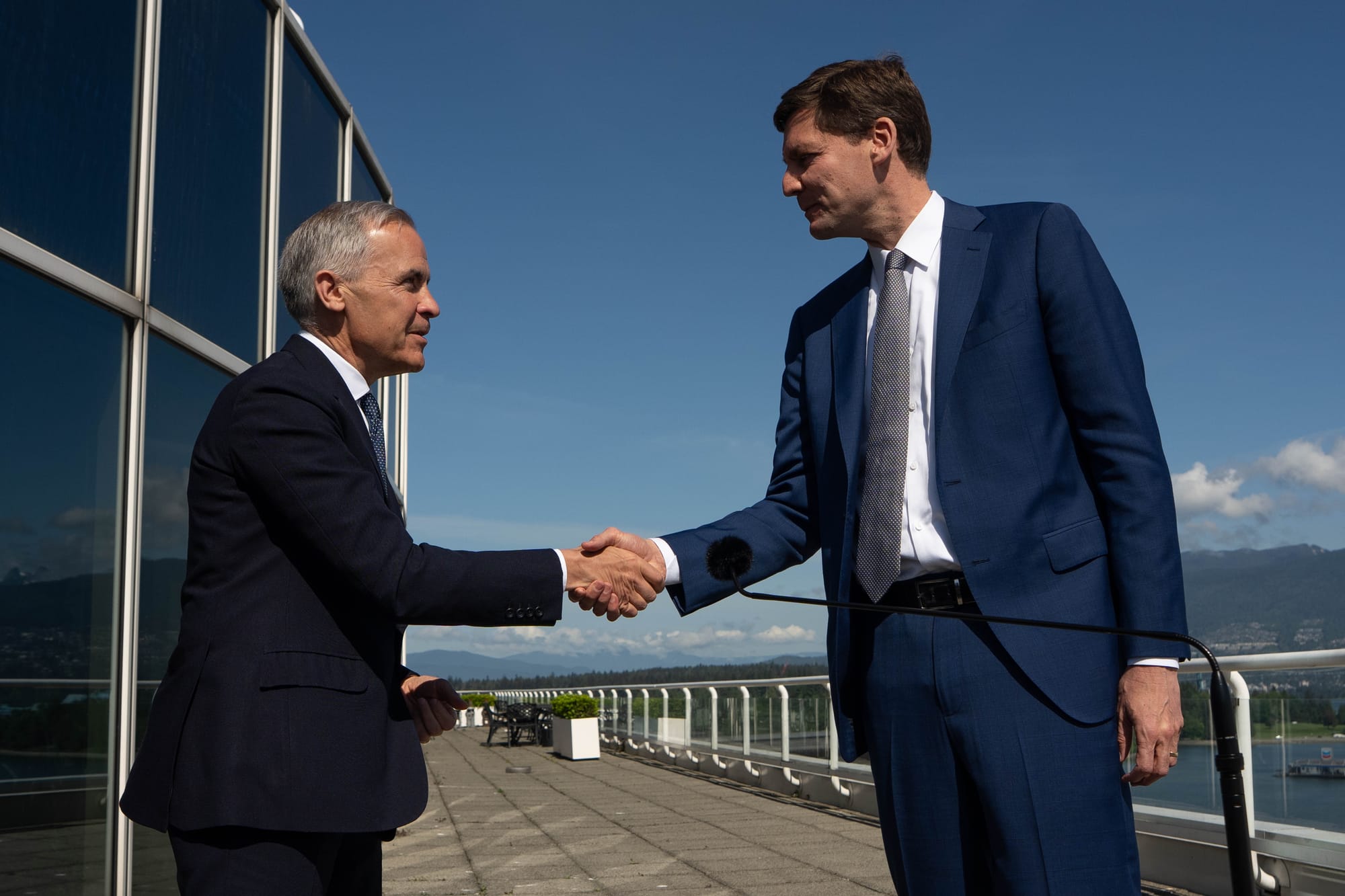 Prime Minister Mark Carney shakes hands with B.C. Premier David Eby before a meeting in Vancouver, on May 20.