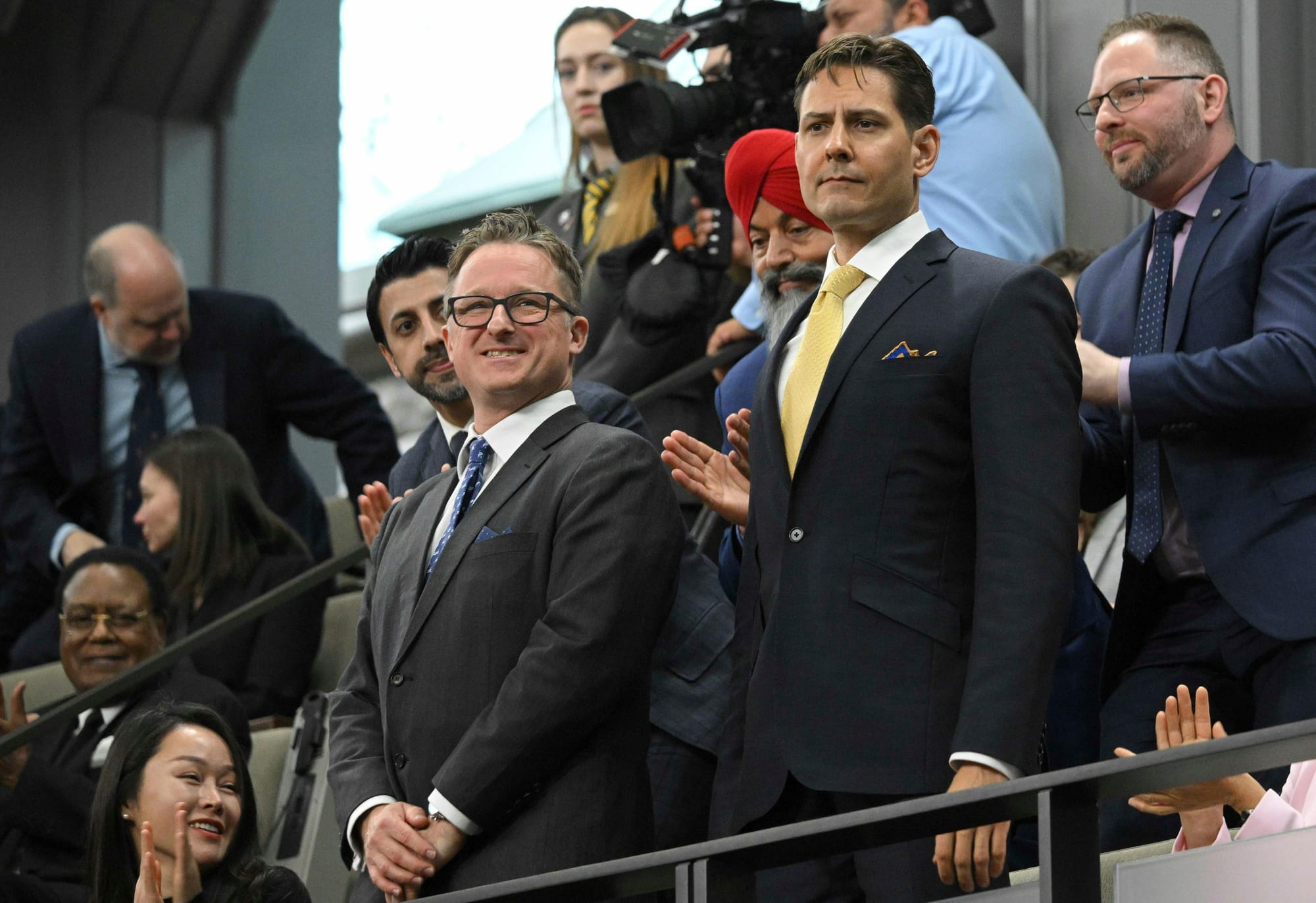 Canadians Michael Spavor and Michael Kovrig stand as they are recognized before former U.S. president Joe Biden speaks to the Canadian Parliament in Ottawa on Mach 24, 2023.