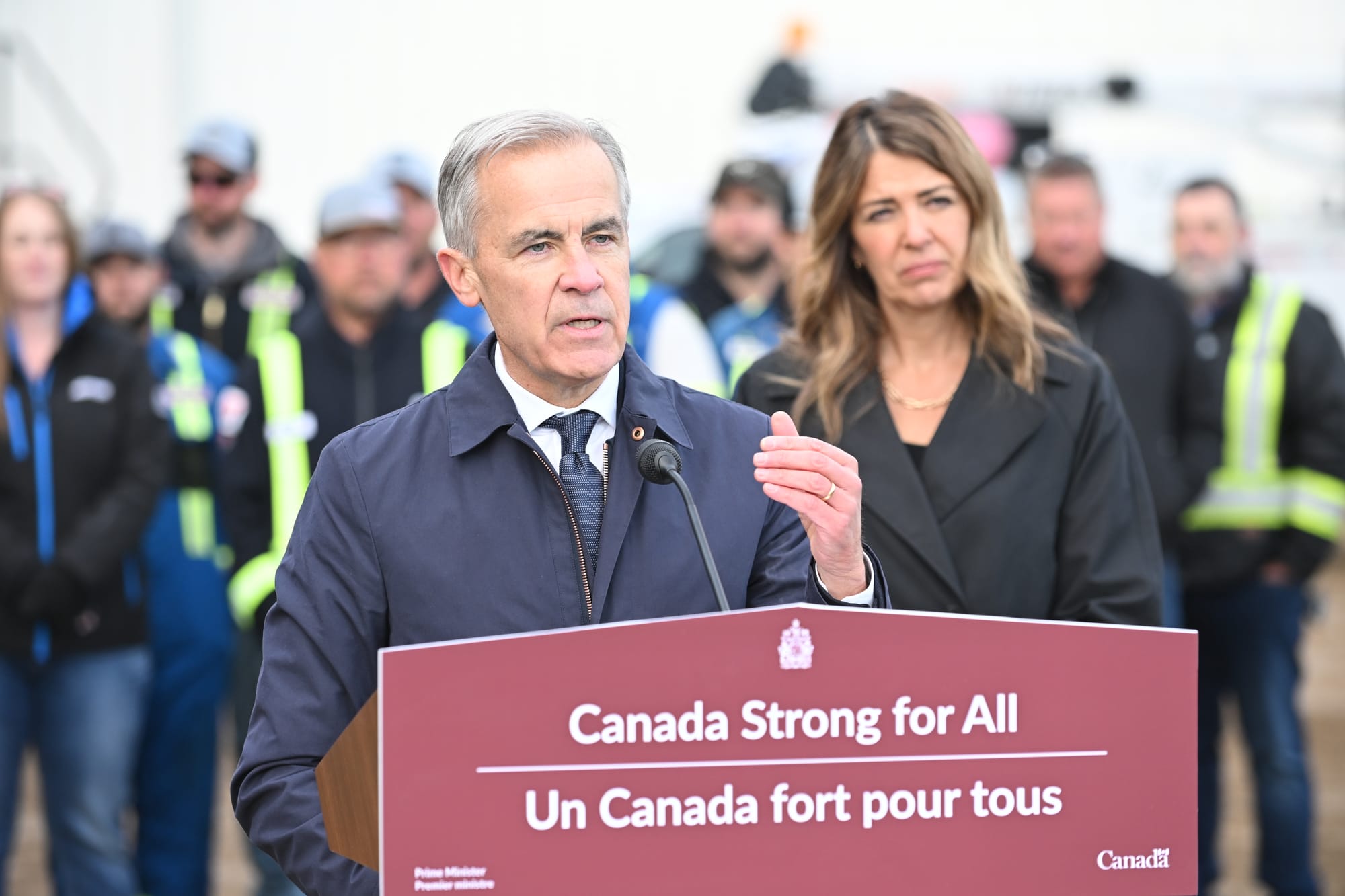 Prime Minister Mark Carney speaks as Alberta Premier Danielle Smith listens in Fort McMurray on Oct 1. 