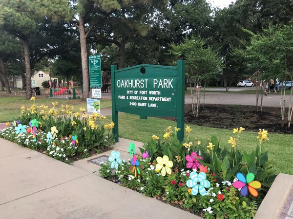 Sign for Oakhurst Park, a central gathering place that hosts community events and holiday celebrations in the Oakhurst neighborhood of Fort Worth, Texas.