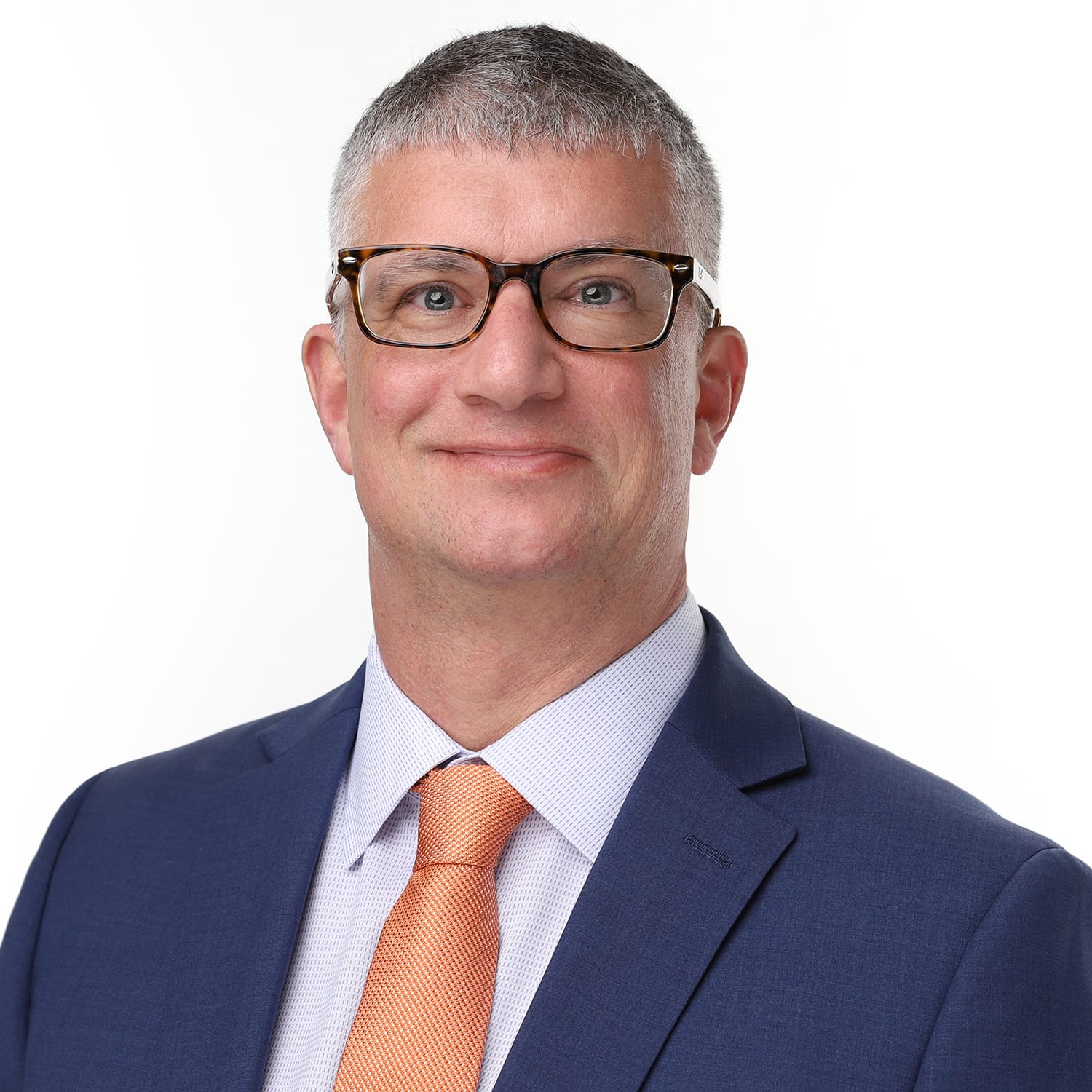 John Mangini, Broker of Record at NextHome Premier, in a dark suit and glasses.