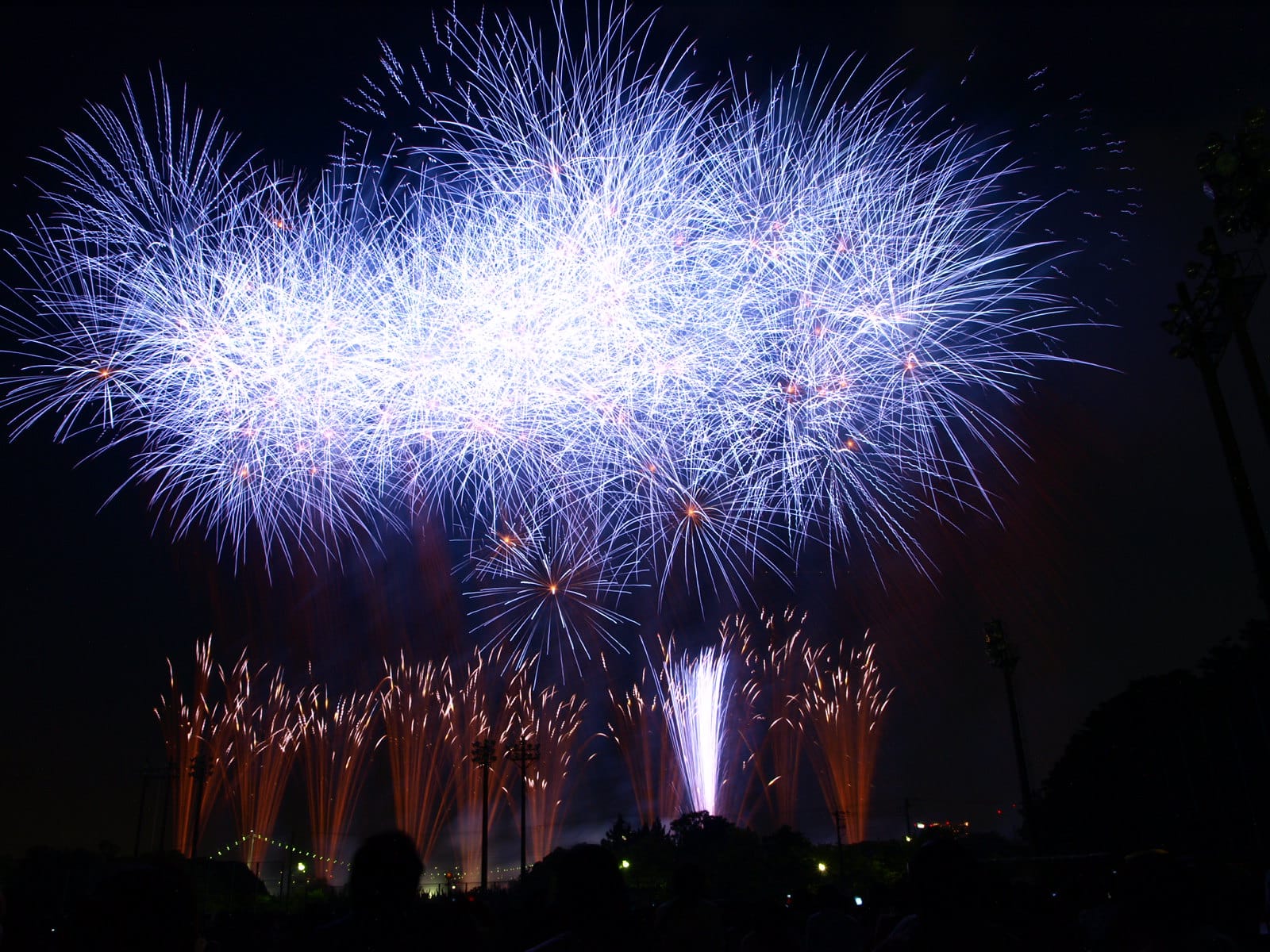 Impressive blue fireworks in Tokyo during a summer festival at night