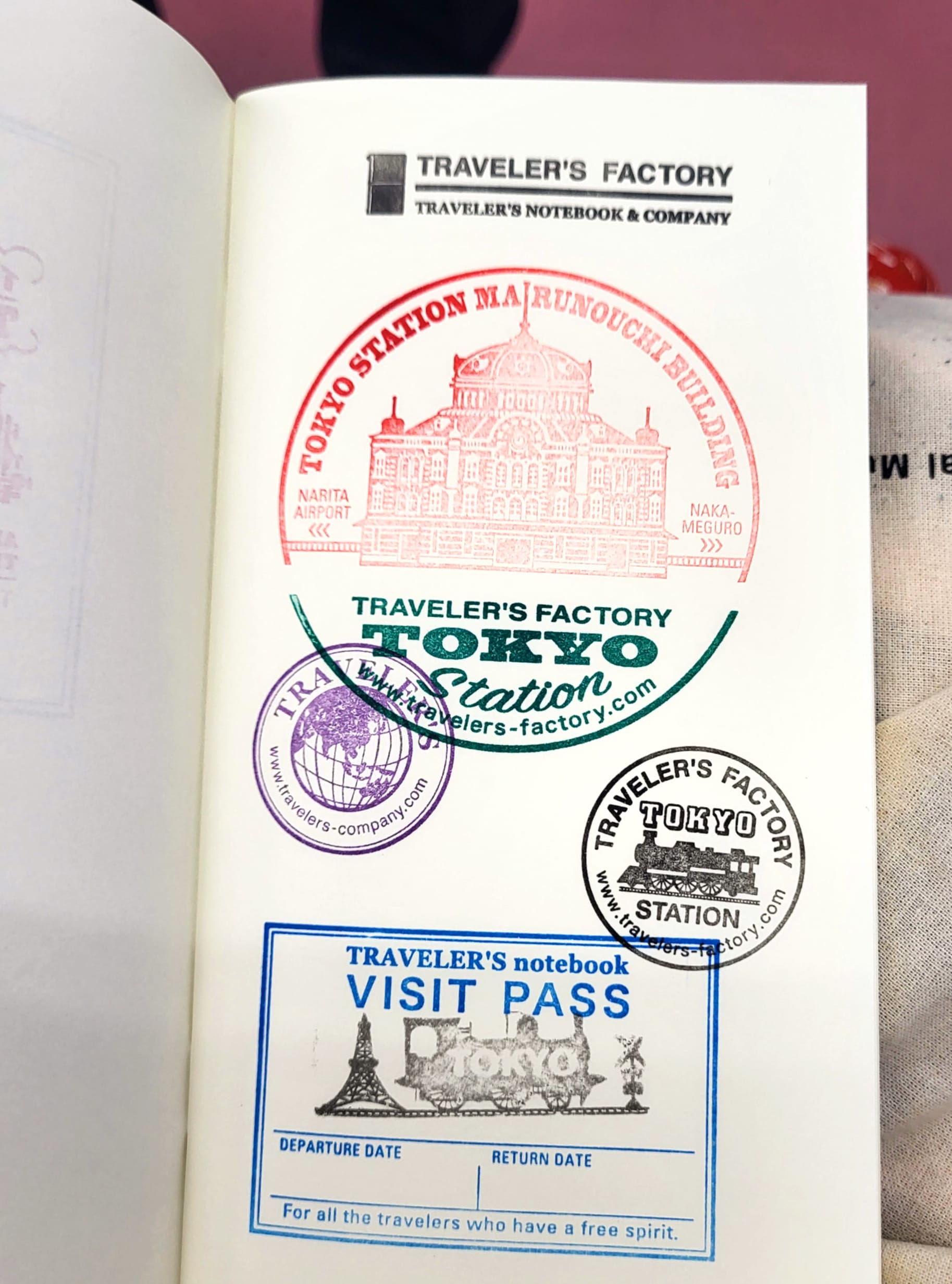 a notebook filled with stamps in Tokyo, Japan