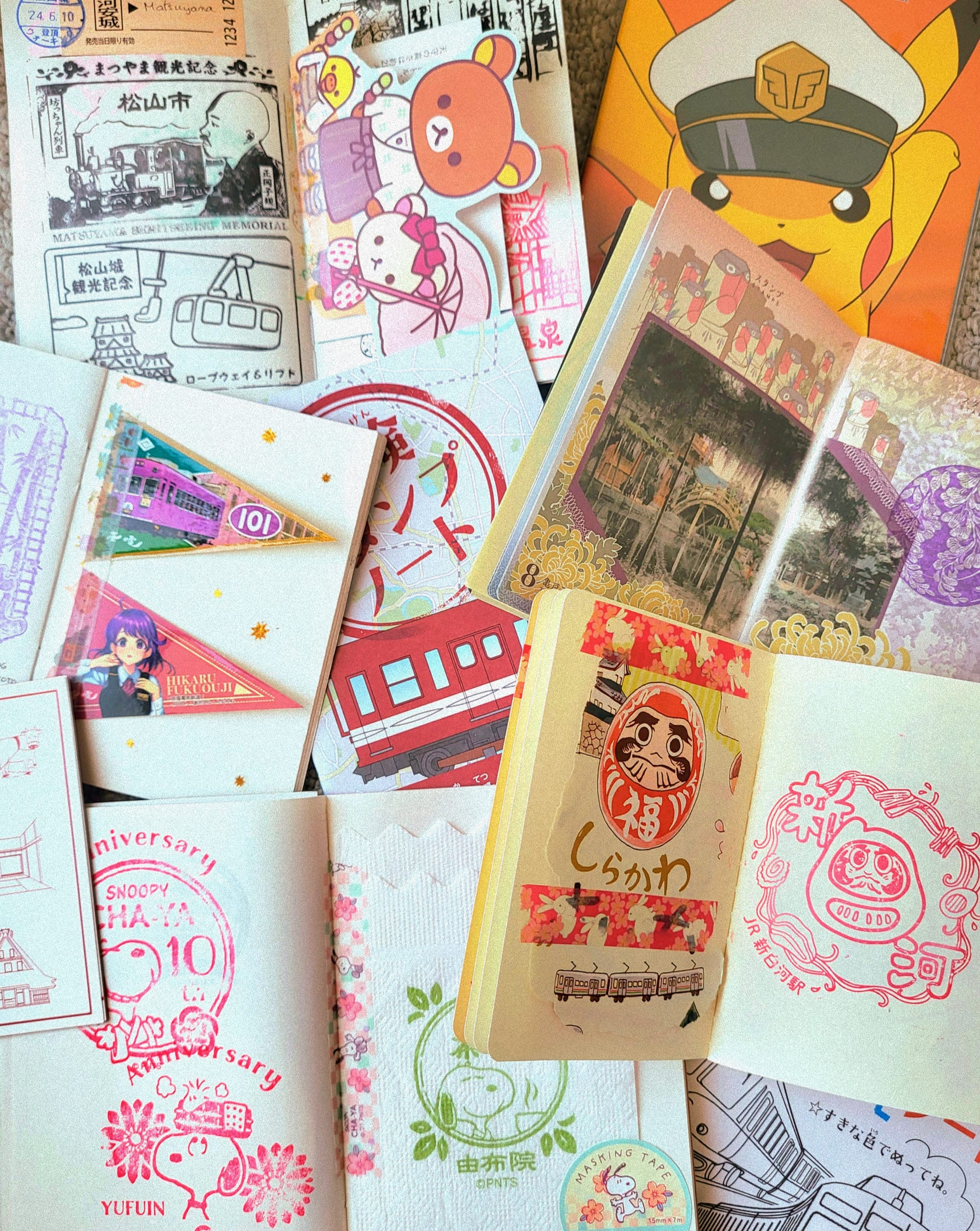 A big collection of notebooks with different stickers and stamps from a trip around Japan