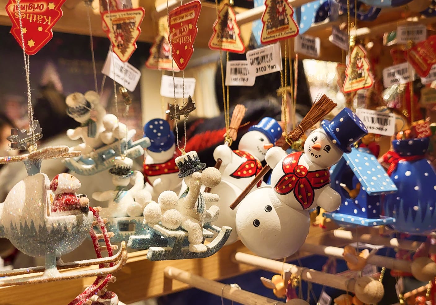 Christmas Ornaments of Snowmen and Santa Clause flying a helicopter