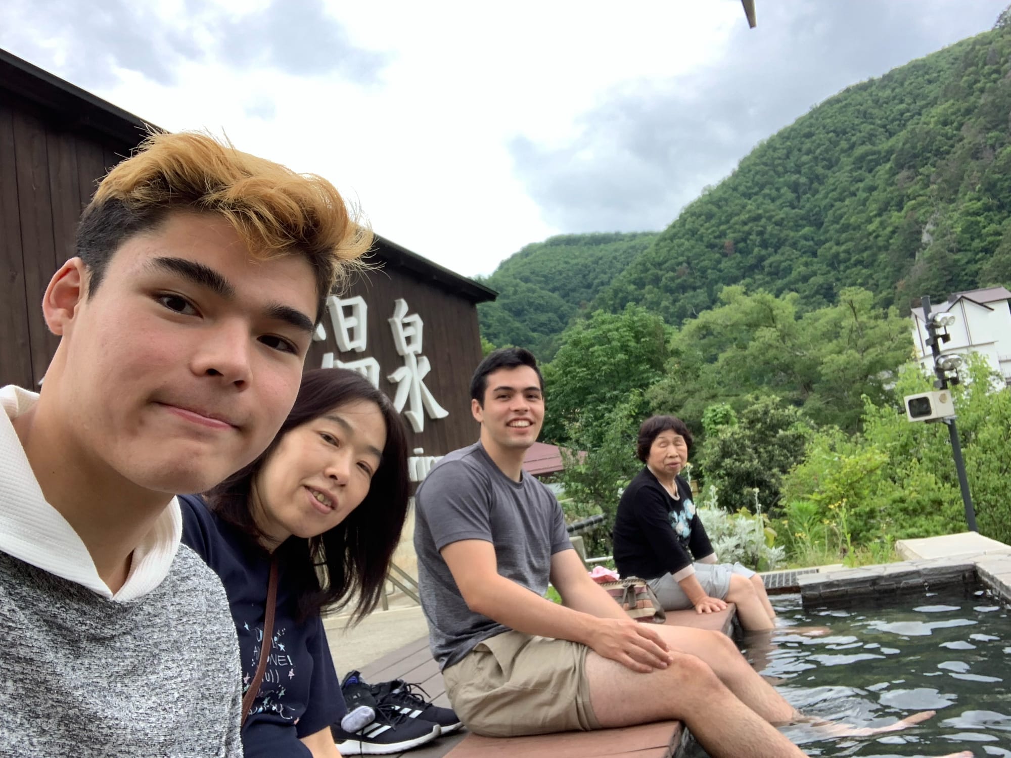 A family of four members enjoying a foot onsen in Fukushima.