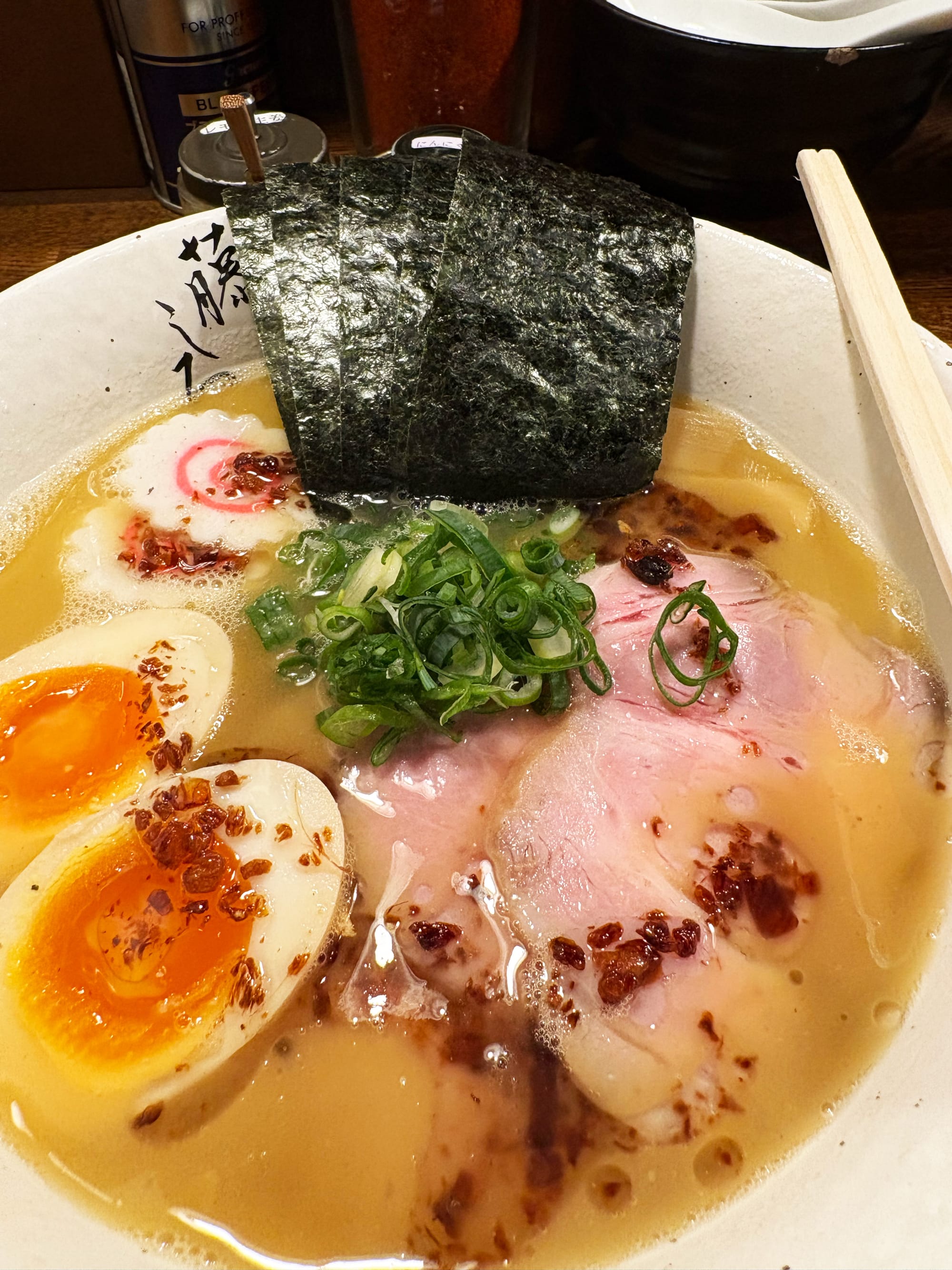 The standard chicken-soup ramen at Menya Fujishiro Meguro. Bowl of ramen with meat, scallions, and egg.