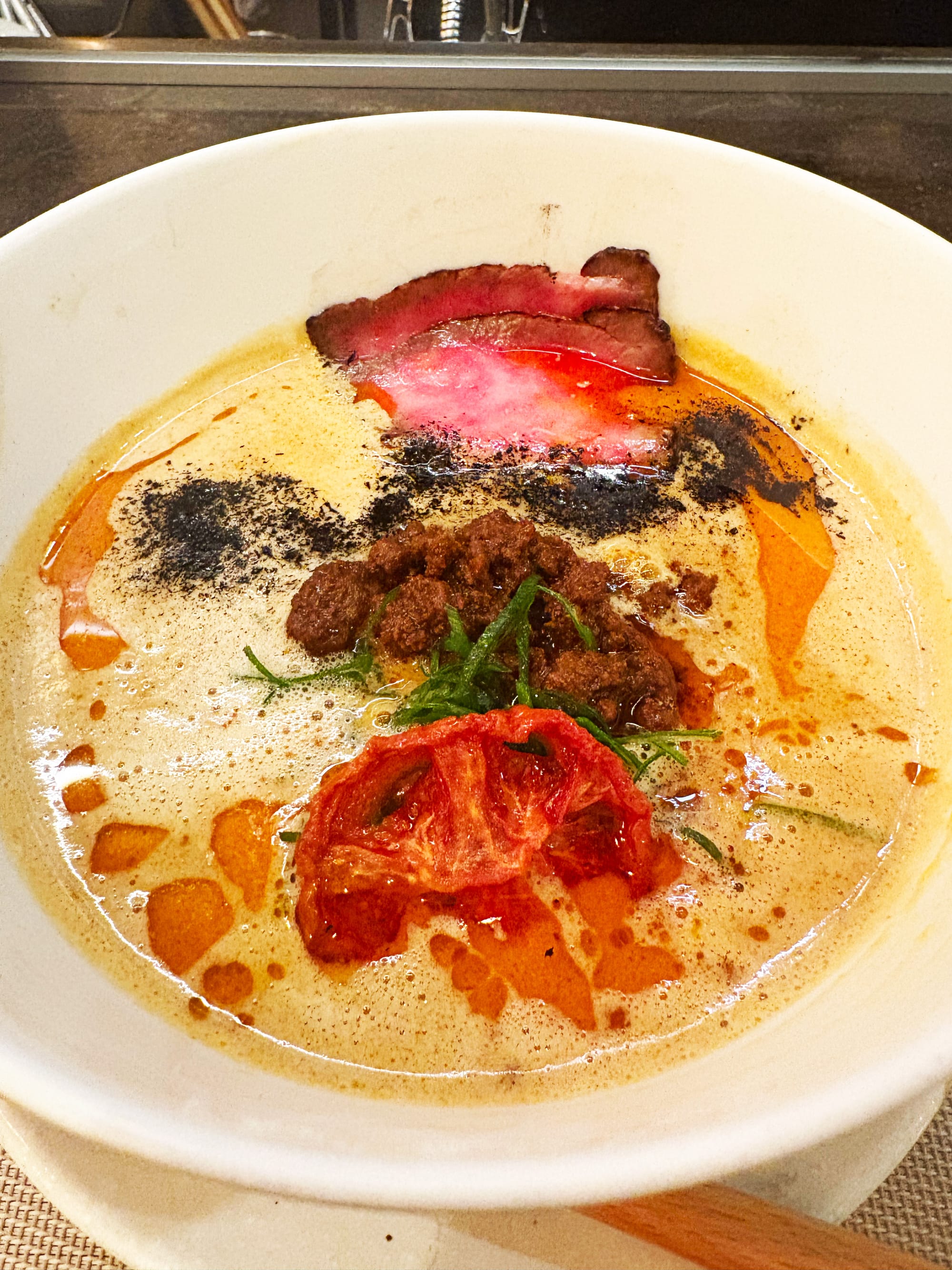 The Wagyu Tantan Ramen at Mensho. Bowl of ramen with meat and tomato.