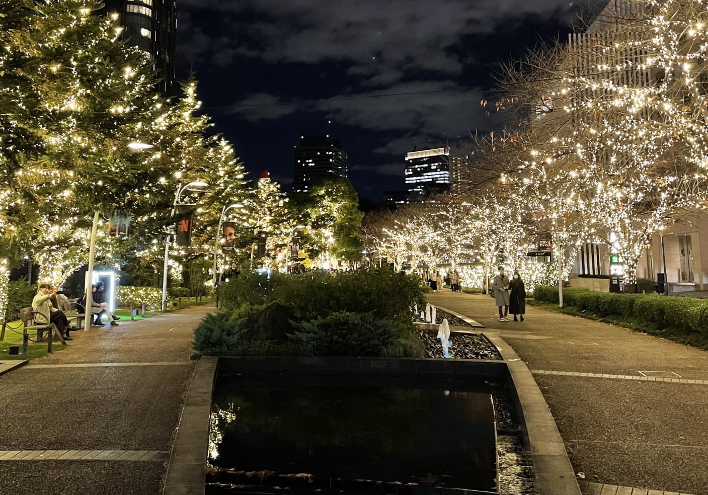 Nighttime Roppongi Midtown Garden with trees adorned in twinkling lights.