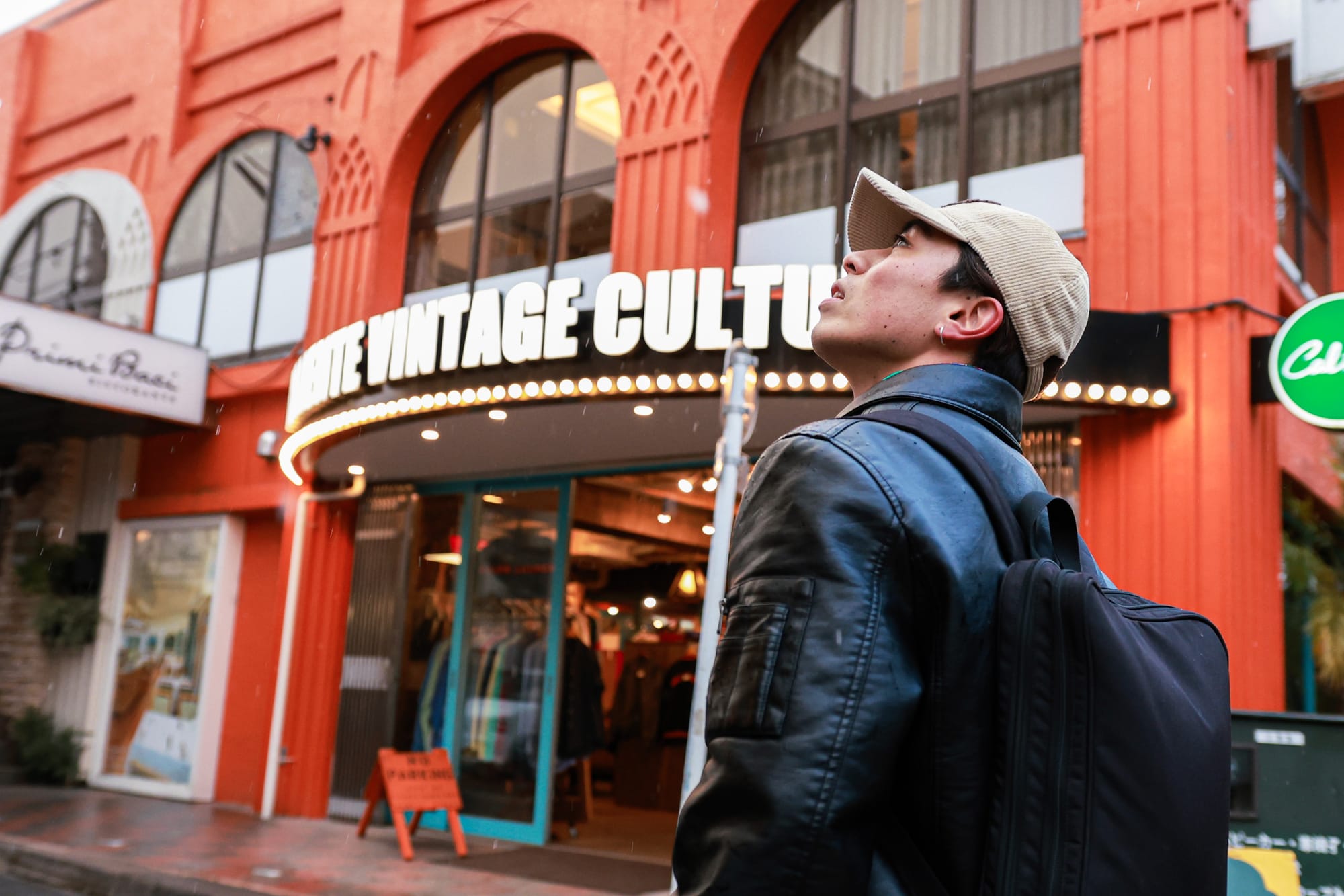 A Japanese young man looking around a street full of shops in Kichijoji, Tokyo.